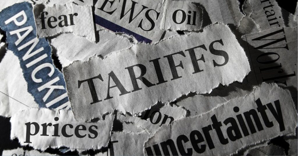 Torn newspaper headlines with words like 'Tariffs', 'Panic', 'Prices', 'Uncertainty', and 'Fear' representing economic tension and trade disruption.